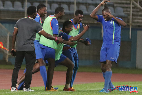 Photo: Police FC captain Todd Ryan (far right) is congratulated his bench after his strike against Club Sando in 2015/16 Pro League action. (Courtesy Chevaughn Christopher/Wired868)