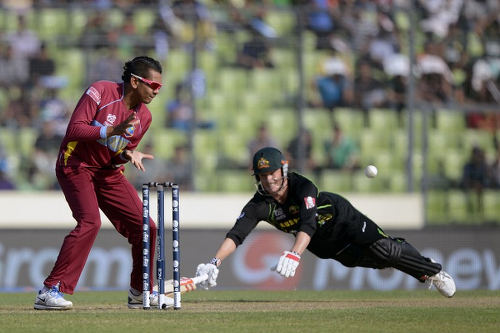 Photo: West Indies cricketer Sunil Narine (left) tries to run out Australia captain George Bailey during the ICC World Twenty20 tournament Group 2 cricket match between Australia and West Indies at The Sher-e-Bangla National Cricket Stadium in Dhaka on 28 March 2014. (Copyright AFP 2016/Munir uz Zaman)