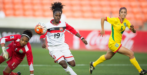 Photo: Trinidad and Tobago attacker Kennya "Yaya" Cordner (centre) prepares to fire him while Guyana goalkeeper Chante Sandiford (left) looks on during CONCACAF 2016 Olympic qualifying action in Houston. (Copyright MexSport/CONCACAF)