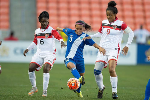 Photo: Trinidad and Tobago international players Khadidra Debesette (left) and Maylee Attin-Johnson (right) try to close down Guatemala midfielder Marilyn Rivera during 2016 Olympic qualifying action. (Courtesy CONCACAF)