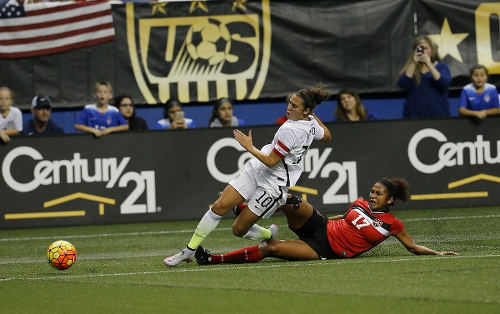 Photo: Trinidad and Tobago midfield anchor Victoria Swift (right) chops down United States captain Carli Lloyd during international friendly action in December 2015. (Copyright AFP 2016/Chris Covatta)