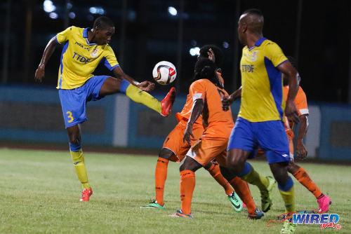 Photo: Defence Force central defender Jamali Garcia (left) in TT Pro League action against Club Sando on 22 January 2016. Garcia was one of seven debutantes for the Trinidad and Tobago National Senior Team against Grenada on March 19. (Courtesy: Chevaughn Christopher/Wired868)