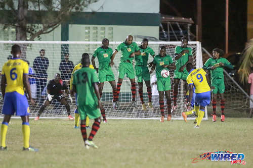 Photo: The San Juan Jabloteh defence tries to withstand a free kick from Defence Force striker Devorn Jorsling (number 9) during Pro League action on 12 March 2016 at the Barataria Recreation Ground. (Courtesy Nicholas Bhajan/Wired868)