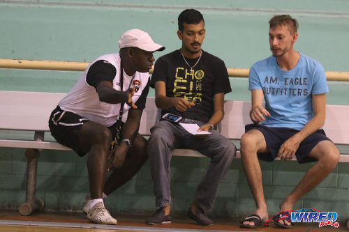 Photo: Trinidad and Tobago National Futsal Team coach Clayton Morris (left) gesticulates during an interview with Wired868 reporter Amiel Mohammed (centre) at the Maloney Indoor Sport Arena. (Courtesy Chevaughn Christopher/CA-images/Wired868)