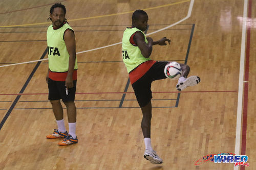 Photo: Trinidad and Tobago Futsal player Kareem Perry (right) flicks the ball while teammate Ricardo Bennett watches on during a national practice session at the Maloney Indoor Sport Arena. (Courtesy: Chevaughn Christopher/CA-images/Wired868)