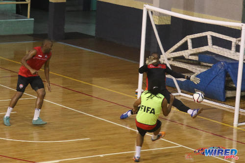 Photo: Trinidad and Tobago National Futsal Team player Ricardo Bennett (right) hits past goalkeeper Kevin Graham during training at the Maloney Indoor Centre. (Courtesy: Chevaughn Christopher/CA-images/Wired868)