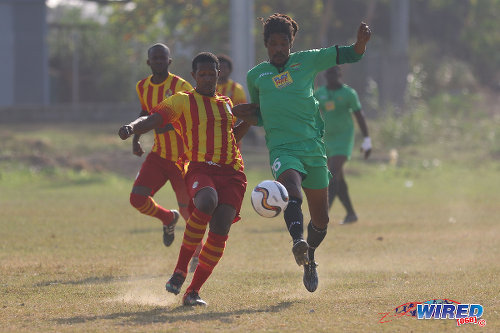 Photo: San Juan Jabloteh midfielder Marvin Oliver (right) completes a pass under pressure from a Point Fortin Civic opponent during TT Pro League action at the Barataria Recreation Ground, Barataria on 5 March 2016. (Courtesy Chevaughn Christopher/Wired868)