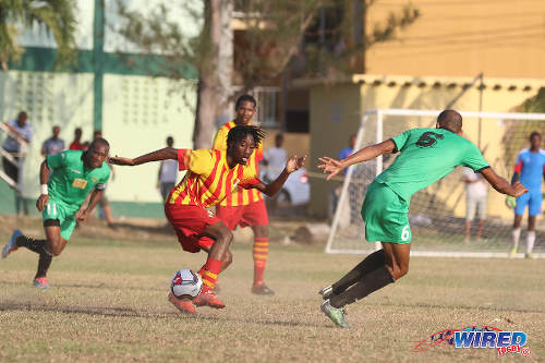 Photo: Point Fortin Civic midfielder Akeem Redhead (centre) runs at San Juan Jabloteh left back Akeem "Battery" Benjamin (right) during TT Pro League action at the Barataria Recreation Ground, Barataria on 5 March 2016. (Courtesy Chevaughn Christopher/Wired868)