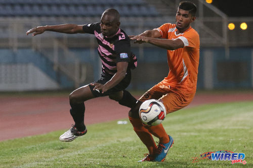 Photo: North East Stars attacker Anthony Wolfe (left) tries to break clear of Club Sando defender Amritt Gildharry during TT Pro League action at the Ato Boldon Stadium on 1 March 2016. (Courtesy Chevaughn Christopher/Wired868)