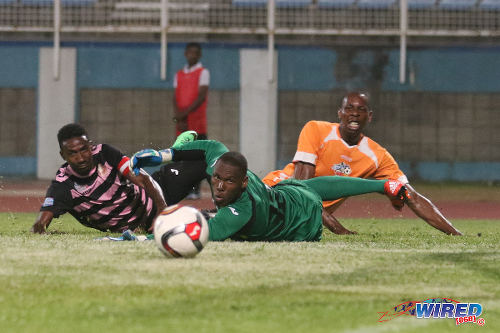 Photo: Club Sando striker Kevon Woodley (right) and North East Stars players Keryn Navarro (left) and goalkeeper Glenroy Samuel watch an effort flash just wide during their TT Pro League clash at the Ato Boldon Stadium on 1 March 2016. (Courtesy Chevaughn Christopher/Wired868)