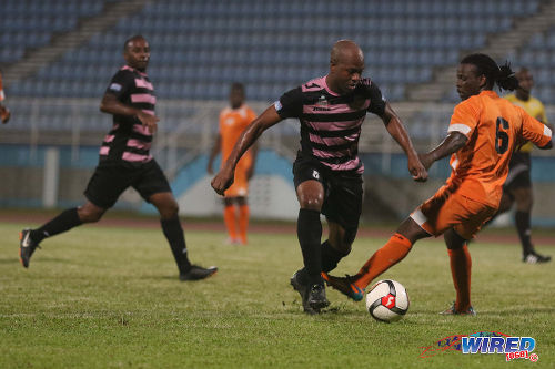 Photo: North East Stars midfielder Ryan "Fry" Stewart (left) dribbles Club Sando left back Kemuel Rivers during their TT Pro League clash at the Ato Boldon Stadium on 1 March 2016. (Courtesy Chevaughn Christopher/Wired868)