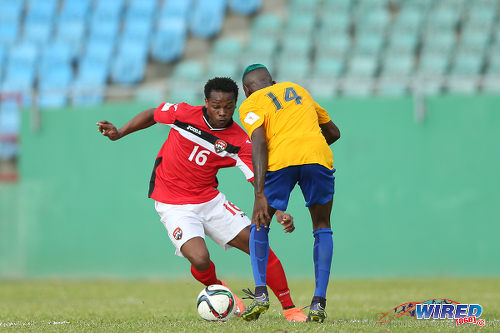 Photo: Trinidad and Tobago winger Levi Garcia (left) prepares to glide past St Vincent and the Grenadines right back Akeem Williams en route to his opening goal in Russia 2018 World Cup qualifying action at Arnos Vale on 25 March 2016. Trinidad and Tobago won 3-2. (Courtesy Allan V Crane/CA-images/Wired868)