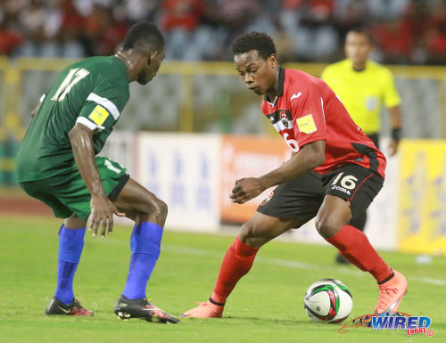 Photo: Trinidad and Tobago winger Levi Garcia (right) tricks his way past St Vincent and the Grenadines player Emerald George during Russia 2018 World Cup qualifying action at the Hasely Crawford Stadium, Port of Spain on 29 March 2016. Trinidad and Tobago won 6-0. (Courtesy: Nicholas Bhajan/Wired868)