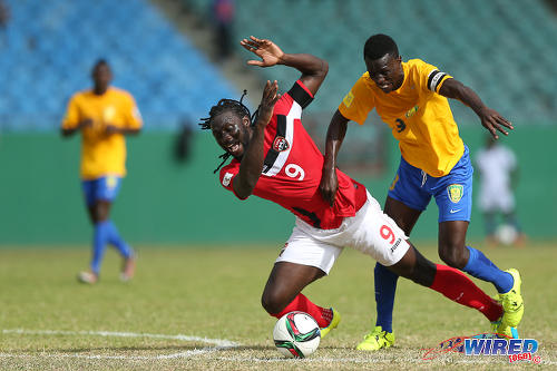 Photo: Trinidad and Tobago captain Kenwyne Jones (left) tussles with St Vincent and the Grenadines captain Roy Richards during Russia 2018 World Cup qualifying action at Arnos Vale on 25 March 2016. Trinidad and Tobago won 3-2. (Courtesy Allan V Crane/CA-images/Wired868)