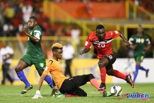 Photo: Trinidad and Tobago forward Trevin Caesar (right) takes the ball around St Vincent and the Grenadines goalkeeper Lemus Christopher during Russia 2018 World Cup qualifying action at the Hasely Crawford Stadium, Port of Spain on 29 March 2016. Trinidad and Tobago won 6-0. (Courtesy: Allan V Crane/CA-images/Wired868)