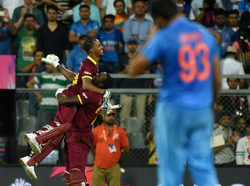 Photo: West Indies cricketer Lendl Simmons (left) celebrates after winning the World T20 cricket tournament semi-final match against India at The Wankhede Cricket Stadium in Mumbai on 31 March 2016. (Copyright AFP 2016/Punit Paranjpe)