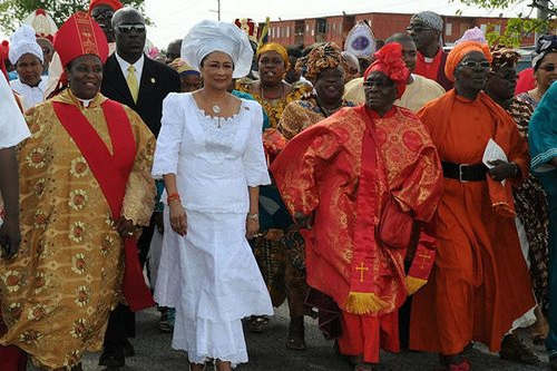 Photo: Then Prime Minister Kamla Persad-Bissessar (centre) celebrates with the Spiritual Baptists. (Courtesy UNCTT)