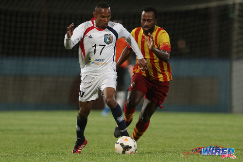 Photo: Morvant Caledonia United Akim Armstrong (left) and Point Fortin Civic midfielder Kelvin Modeste during Lucozade Sport Goal Shield qualifying action on 5 April 2016 at the Ato Boldon Stadium, Couva (Courtesy Chevaughn Christopher/CA-images/Wired868)