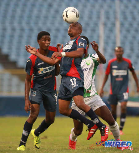 Photo: Morvant Caledonia United playmaker Akim Armstrong (centre) wins a header during the Lucozade Sport Goal Shield final against W Connection on 21 April 2016. Caledonia won 4-1 on kicks from the penalty mark. (Courtesy Nicholas Bhajan/Wired868)