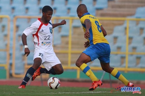 Photo: Morvant Caledonia United utility player Jameel Neptune (left) takes on Defence Force player Curtis Gonzales during Lucozade Sport Goal Shield quarterfinal action on 9 April 2016. (Courtesy Nicholas Bhajan/Wired868)