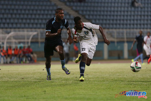 Photo: Morvant Caledonia United utility player Jameel "Shooter" Neptune (right) tries to evade Police FC right back Jibiri McDavid during the Lucozade Sports Goal Shield semifinals on 15 April 2016 in Couva. Morvant Caledonia won 3-1 on kicks from the penalty mark. (Courtesy Chevaughn Christopher/Wired868)