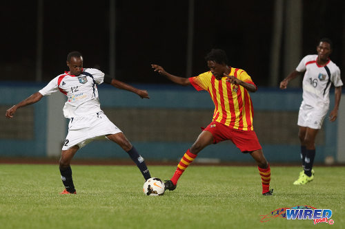 Photo: Morvant Caledonia United captain Kareem "Tiny" Joseph (left) tries to reach the ball before a Point Fortin Civic opponent during Lucozade Sport Goal Shield qualifying action on 5 April 2016 at the Ato Boldon Stadium, Couva (Courtesy Chevaughn Christopher/CA-images/Wired868)