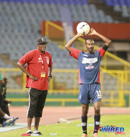 Photo: Morvant Caledonia United coach Jerry Moe (left) looks on as team captain Kareem "Tiny" Joseph prepares to take a throw during the Lucozade Sport Goal Shield final against W Connection. Caledonia won 4-1 on kicks from the penalty mark. (Courtesy Nicholas Bhajan/Wired868)