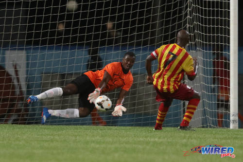 Photo: Morvant Caledonia United goalkeeper Marvin Phillip (left) stops a penalty kick from Point Fortin Civic captain Nickcolson Thomas during Lucozade Sport Goal Shield qualifying action on 5 April 2016 at the Ato Boldon Stadium, Couva (Courtesy Chevaughn Christopher/CA-images/Wired868)