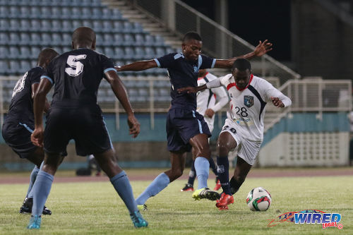 Photo: Morvant Caledonia United striker Pernell Schultz (right) in action against Police FC in the Lucozade Sports Goal Shield semifinals on 15 April 2016 in Couva. Morvant Caledonia won 3-1 on kicks from the penalty mark, after Schultz scored his team's lone goal in a 1-1 tie at regulation time. (Courtesy Chevaughn Christopher/Wired868)