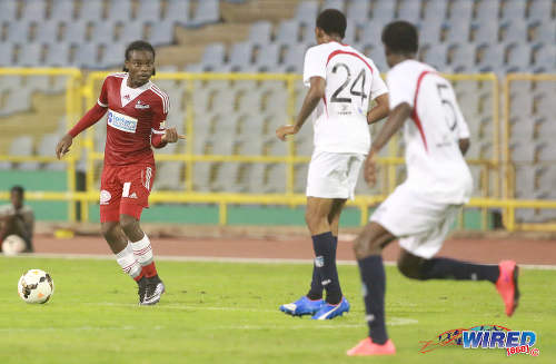 Photo: Central FC midfielder Darren Mitchell (left) gestures with his hand while two Morvant Caledonia United defenders stand guard during Pro League on 19 April 2016 at the Hasely Crawford Stadium. Central won 3-0. (Courtesy Nicholas Bhajan/Wired868)