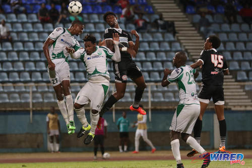 Photo: Central FC forward Nicholas Dillon (centre) challenges W Connection defenders Jelani Peters (far left) and Maurice Ford (second from left) in the air during the Lucozade Sport Goal Shield semifinals on 15 April 2016. Connection won 4-2. (Courtesy Chevaughn Christopher/Wired868)