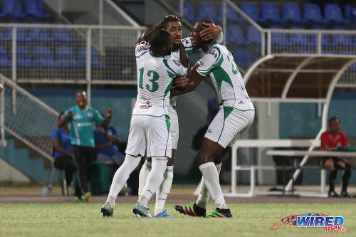 Photo: W Connection defender Alvin Jones (centre) is congratulated by teammates Daneil Cyrus (right) and captain Hughtun Hector after his goal against Central FC in the Lucozade Sport Goal Shield semifinal on 15 April 2016. Connection won 4-2. (Courtesy Chevaughn Christopher/Wired868)