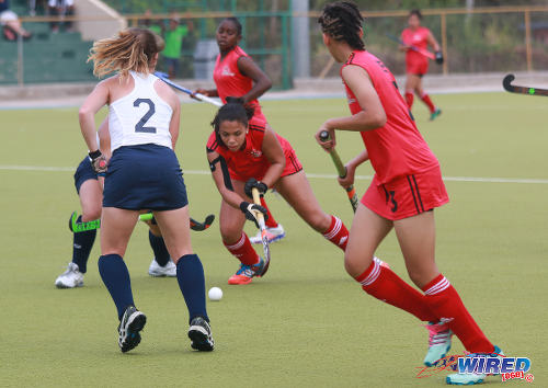 Photo: Trinidad and Tobago midfielder Brianna Govia (second from right) tries to get the ball past some United States opponents during their opening fixture of the 2016 Women's Junior Pan American Championship in Tacarigua on Thursday 31 March 2016. (Courtesy Nicholas Bhajan/Wired868)