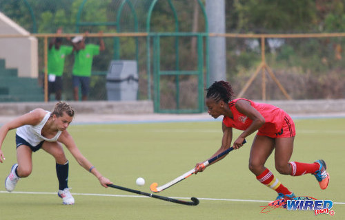 Photo: Trinidad and Tobago captain Kayla Brathwaite (right) dribbles past a United States opponent during their opening fixture of the 2016 Women's Junior Pan American Championship in Tacarigua on Thursday 31 March 2016. (Courtesy Nicholas Bhajan/Wired868)