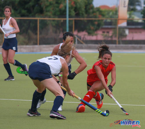 Photo: Trinidad and Tobago player Samantha Olton (right) tries to squeeze a pass past a United States opponent during their opening fixture of the 2016 Women's Junior Pan American Championship in Tacarigua on Thursday 31 March 2016. (Courtesy Nicholas Bhajan/Wired868)