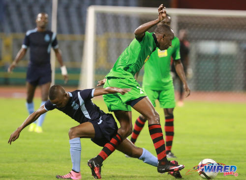 Photo: San Juan Jabloteh full back Noel Williams (right) takes on Police FC flanker Clevon McFee during Lucozade Sport Goal Shield quarterfinal action on 9 April 2016. Police won 3-0. (Courtesy Nicholas Bhajan/Wired868)