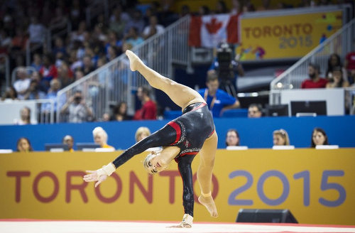 Photo: Trinidad and Tobago gymnast Marisa Dick competes on the floor exercise in the women's artistic gymnastics team event at the 2015 Pan American Games in Toronto, Canada on 12 July 2015. (Copyright AFP 2016/Kevin Van Paassen)