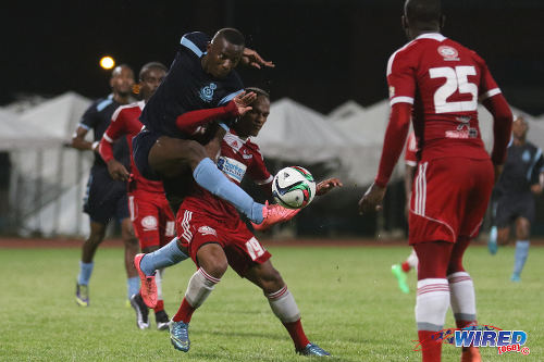 Photo: Police FC striker Jameel Perry (left) intercepts the ball from Central FC midfielder Nathaniel Garcia (centre) during TT Pro League action on 2 April 2016. Police FC won 1-0. (Courtesy Chevaughn Christopher/CA-images/Wired868)