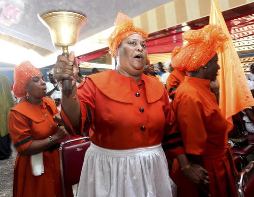 Photo: Spiritual Baptists ring the bell. (Copyright Washington Post)