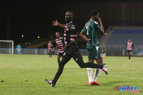 Photo: North East Stars forward Gorean Highley (left) celebrates his decisive strike while W Connection left back Kurt Frederick looks on during TT Pro League action on 2 April 2016. Police FC won 1-0. (Courtesy Chevaughn Christopher/CA-images/Wired868)