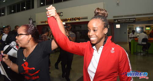 Photo: Trinidad and Tobago gymnast Thema Williams (right) is welcomed home from Rio by her godmother and entertainer Nikki Crosby at the Piarco International Airport on Wednesday 20 April 2016. (Courtesy Wired868)