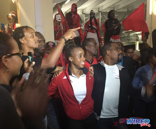 Photo: Trinidad and Tobago gymnast Thema Williams (centre) hugs relatives as she is welcomed home from Rio by her fans at the Piarco International Airport on Wednesday 20 April 2016. (Courtesy Lou-Ann Sankar/Wired868)