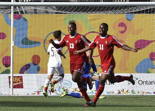 Photo: Trinidad and Tobago National Under-23 attacker Shackiel Henry (right) celebrates his goal against Mexico with teammate and Ricardo John, during the Toronto 2015 Pan American Games in Hamilton, Canada, on 21 July 2015.  (Copyright AFP 2016/Omar Torres)