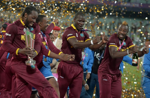 Photo: West Indies cricket players (from left) Chris Gayle, Dwayne Bravo, Darren Sammy and Andre Russell celebrate their World T20 cricket tournament final win over England at The Eden Gardens Cricket Stadium in Kolkata on 3 April 2016. Carlos Brathwaite sensationally hit four successive sixes off Ben Stokes in the last over as the West Indies stunned England by four wickets to win the World Twenty20 title. (Copyright AFP2016/Dibyangshu Sarkar)