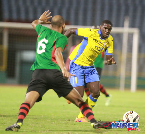 Photo: Defence Force midfielder Akeem Roach (right) takes on San Juan Jabloteh defender Akeem Benjamin during 2016 Pro Bowl semifinal action on May 13 at the Hasely Crawford Stadium in Port of Spain. Defence Force won 1-0. (Courtesy Nicholas Bhajan/Wired868)