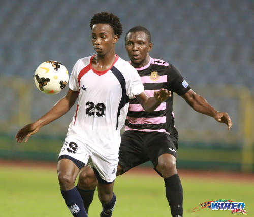 Photo: Morvant Caledonia United attacker Kareem Knights (left) tries to keep the ball from North East Stars midfielder Neil Mitchell during Pro League action at the Hasely Crawford Stadium on 3 May 2016. Stars won 3-2. (Courtesy Nicholas Bhajan/Wired868)