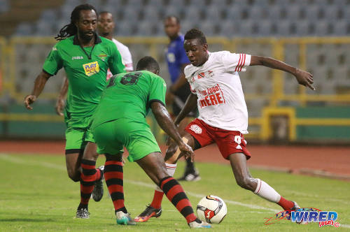 Photo: Central FC attacker Kadeem Corbin (right) takes on San Juan Jabloteh players Jevon Morris (centre) and Keyon Edwards during Pro League action on 17 May 2016 at the Hasely Crawford Stadium. Corbin scored from the penalty spot but Jabloteh held on for a 3-2 win. (Courtesy Nicholas Bhajan/Wired868)