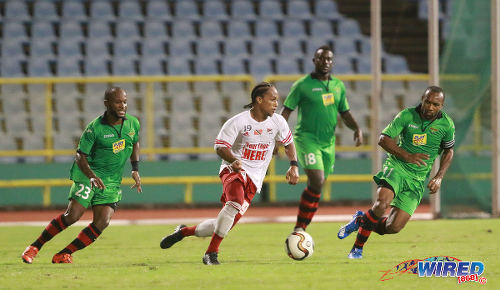 Photo: Central FC midfielder Nathaniel Garcia runs with the ball while San Juan Jabloteh players (from left) Kennedy Hinkson, Keyon Edwards and Damian Williams keep watch during Pro League action on 17 May 2016 at the Hasely Crawford Stadium in Port of Spain. Jabloteh won 3-2. (Courtesy Nicholas Bhajan/Wired868)