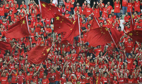 Photo: China football fans get behind their national team. (Copyright SCMP.com)