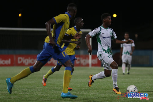 Photo: W Connection utility player Aikim Andrews (right) looks for attacking options while Defence Force players (from left) Akile Edwards and Jerwyn Balthazar try to keep up during the Digicel Pro Bowl final at the Ato Boldon Stadium on 27 May 2016. Andrews scored once but Defence Force clinched the title after a 2-1 win. (Courtesy Chevaughn Christopher/Wired868)